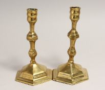A PAIR OF 18TH CENTURY BRASS CANDLESTICKS on hexagonal bases 7 ins high.