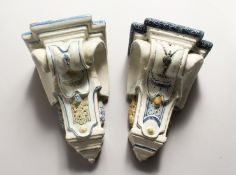 A PAIR OF MAJOLICA BRACKETS with painted decoration. 9ins long