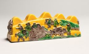 A CHINESE YELLOW PORCELAIN BRUSH REST 5ins long.