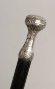 A WALKING CANE with SILVER HANDLE Engraved `POUR COMBLE DE BONHERT' 31ins long