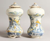 A PAIR OF ITALIAN MAJOLICA SPICE JARS AND COVERS painted with figures in blue and yellow. `TO