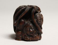A JAPANESE CARVED WOOD DRAGON NETSUKE