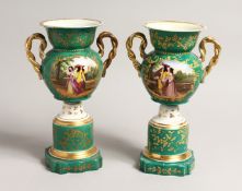 A PAIR OF 19TH CENTURY PARIS GREEN GROUP TWO HANDLED URNS with reverse panels of figures and flowers