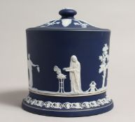 A WEDGWOOD JASPER WARE BLUE AND WHITE BISCUIT BARREL AND COVER