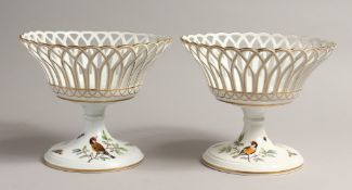 A GOOD PAIR OF 2OTH CENTURY MEISSEN PIERCED PEDESTAL BASKET painted with birds. 8.5ins diameter 7