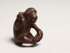 A JAPANESE CARVED WOOD MONKEY NETSUKE