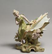 IN THE MANNER OF ROYAL DUX - A SHELL with young lady and cherub on a scrolled stand.