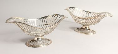 A PAIR OF SILVER OVAL PEDESTAL BASKETS, of openwork design, with reeded borders and foot rim.