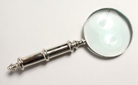A MAGNIFYING GLASS with chrome handle