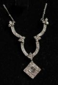 AN 18CT GOLD AND DIAMOND PENDANT AND CHAIN