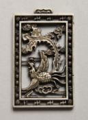 A CHINESE SILVER PIERCED PENDANT