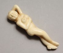 A CARVED BONE DOCTOR'S NUDE 3.5ins long.
