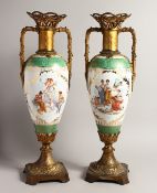 A TALL PAIR OF 19TH CENTURY CONTINENTAL PORCELAIN TWO HANDLED SLENDER VASES with reverse scenes of