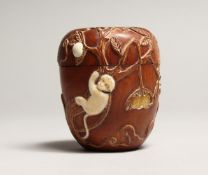 A JAPANESE WOOD AND BONE DRUM BOX with fruit and monkeys. 3ins high.