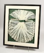 A SUPERB NAPOLEON III WHITE LACE FOR A COT, framed and glazed. 19in x 15ins.