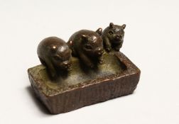 A GOOD JAPANESE BRONZE THREE PIGS AT A TROUGH 2ins