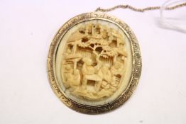 A Chinese Canton ivory and yellow metal mounted brooch, possibly gold.
