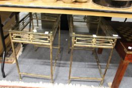 A pair of metal framed glass topped lamp tables.