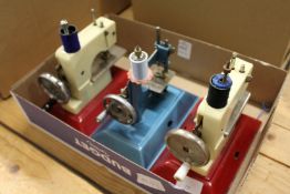 Three children's sewing machines.