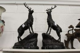 After Moigniez, a pair of bronze stags on rocky bases.