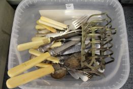 Plated flatware and a toast rack.