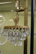 A brass and cut glass small chandelier.