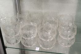 A set of twenty two glass finger bowls, all with grape and vine etched and engraved decoration.