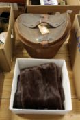 A leather hat box containing an original top hat together with a ladies' fur stole.