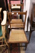 A pair of Edwardian cane seated occasional chairs.