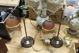 A pair of decorative brass adjustable table lamps.