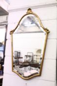 A gilt framed shield shaped mirror.