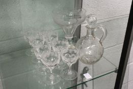 A glass claret jug with engraved vine leaf decoration together with a similar pedestal bowl and
