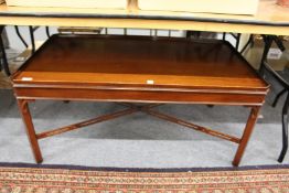 A mahogany tray top rectangular coffee table.