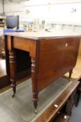 A 19th century mahogany rectangular drop leaf gate leg dining table.