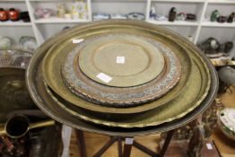 An eastern brass tray table and various other eastern trays.