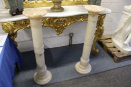 A pair of turned alabaster columns.