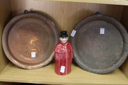 Two Johnnie Walker embossed copper advertising pub trays together with a figural liqueur bottle.