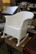 A Lloyd Loom style rocking armchair.