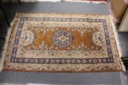 A Persian style beige ground carpet.