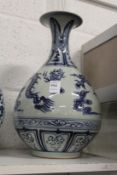 A large Chinese blue and white vase decorated with dragons chasing the pearl of wisdom.