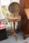 A Victorian style mahogany tripod wash stand with circular mirror.