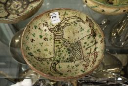 Decorative painted and incised Islamic pottery bowl.