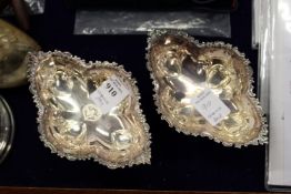 A pair of white metal pedestal salts, possibly eastern silver.