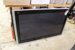 A large Panasonic flat screen TV with wall mounting bracket.