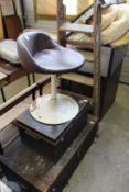 An old pair of step ladders, a small swivel chair and two trunks.