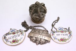 A silver mounted bottle stopper in the form of a crown and various decanter labels.
