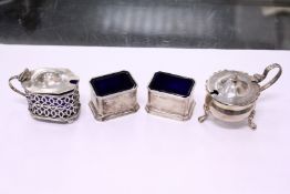 A pair of silver salts and two mustard pots.