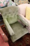 A Victorian button upholstered open armchair.