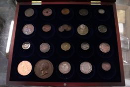 A quantity of coins and tokens housed in a purpose made travelling case.