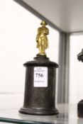 A small gilt metal model of Napoleon standing on a circular marble base.